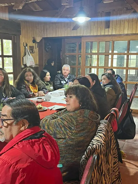Participantes escuchan la exposición desde su mesa